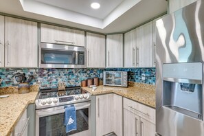 A modern kitchen with stainless steel appliances, a microwave, a stove, and a toaster. - Right on the beach!South Padre Island Luxury stay! (South Padre Island)