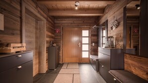 A wooden interior with a door, cabinets, and a bench. - Superior Chalet Im Weidach (Leutasch)