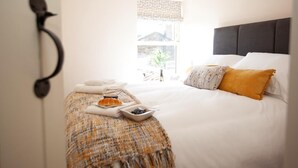 A hotel room with a bed, pillows, a bedside table with a tray of breakfast, and a window with a view. - 2 Bed in Richmond (oc-74284) (Reeth)