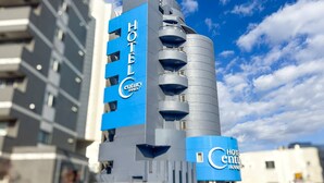 A modern hotel with a prominent blue and grey facade, a cylindrical tower, and balconies. - hotel CenturyANNEX (Chiba)