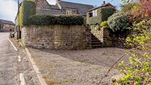 A stone wall with a staircase leading to a house with a tiled roof. - 2 Bed in Matlock (oc-81116) (Crich)