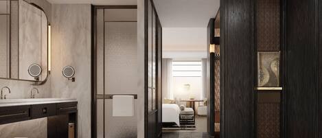 A modern bathroom with a large mirror, two round mirrors, a dark wood vanity, and a patterned floor.