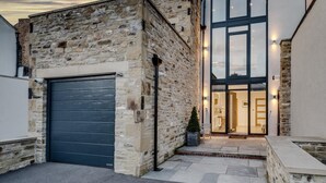 A stone building with a garage and a large glass door entrance. - 4 Bed in Richmond (oc-83250) (Richmond)