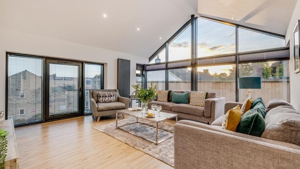 A spacious living room with a large window, a sofa set, a coffee table, and a fireplace. - 4 Bed in Richmond (oc-83250) (Richmond)
