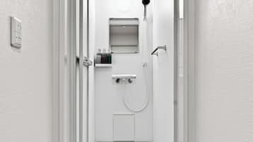 A modern bathroom with a shower, toilet, and sink.