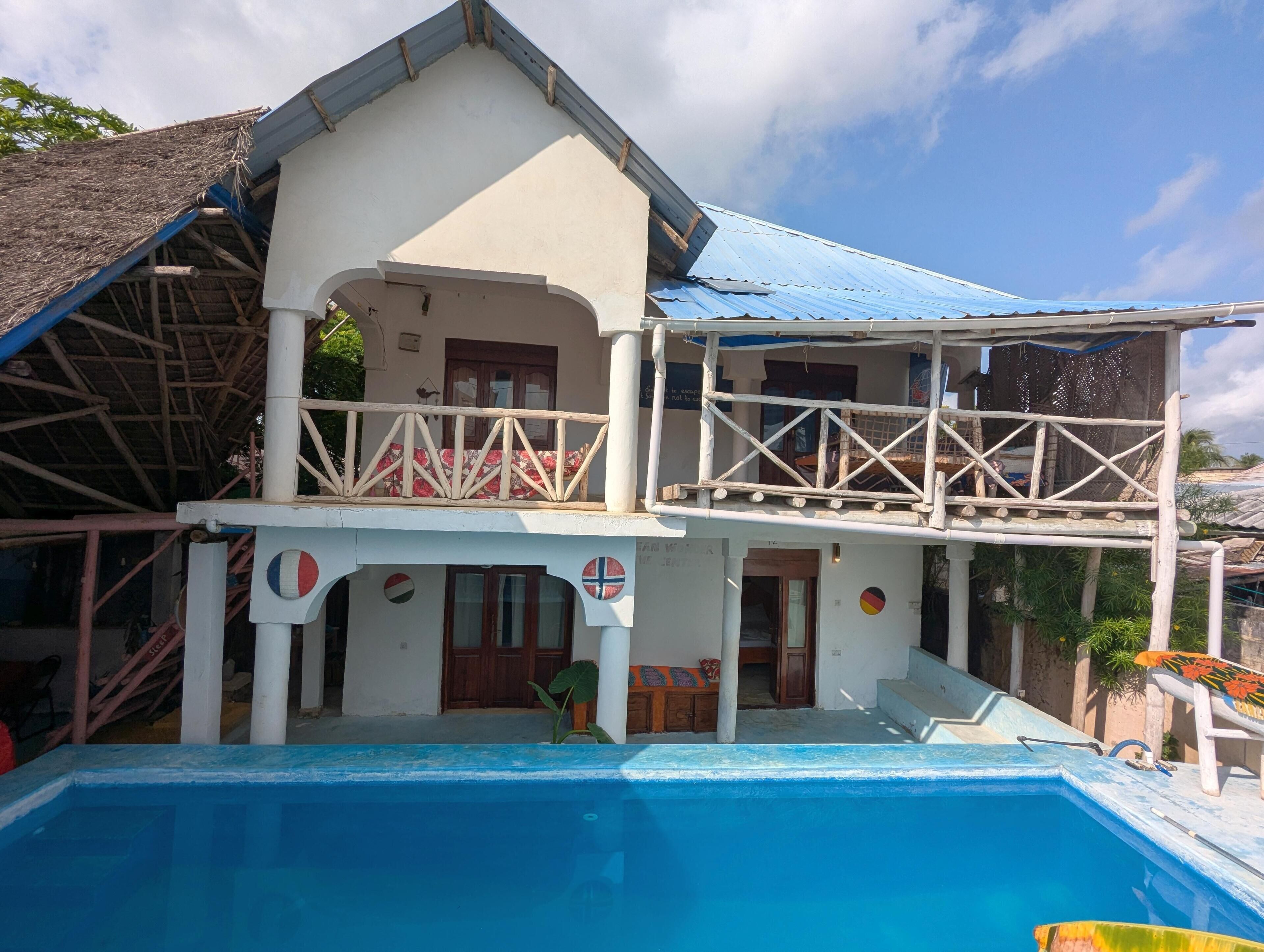 A two-story building with a swimming pool.