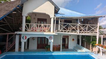 A two-story building with a swimming pool.