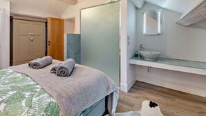 A bedroom with a bed, a bathroom with a sink, and a wooden ceiling. - 2 Bed in Settle (oc-g0051) (Settle)