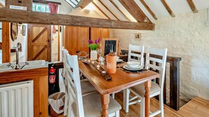 A rustic dining area with a wooden table, white chairs, and a 'NO SMOKING' sign. - 1 Bed in Sheffield (oc-pk417) (Sheffield)