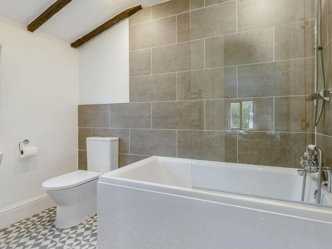 A bathroom with a bathtub, toilet, and a shower.