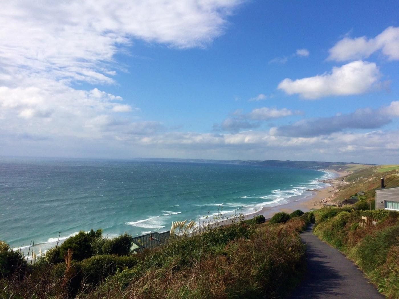 A coastal road with a view of the sea and beach.