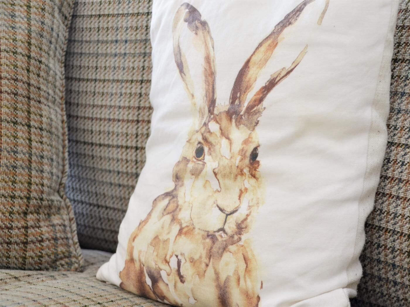 A pillow with a rabbit design.