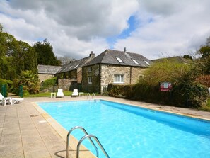 A stone building with a swimming pool, white lounge chairs, and a no smoking sign. - 3 Bed in Liskeard (oc-47663) (Liskeard)