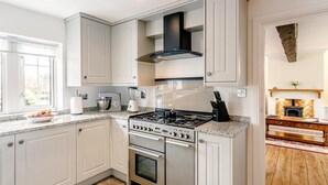 A modern kitchen with white cabinetry, a gas stove, and a built-in oven. - 1 Bed in Sheffield (oc-48259) (Thurlstone)