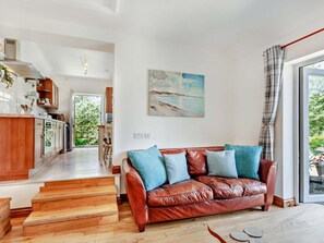 A modern living space with a leather sofa, wooden flooring, and a painting on the wall. - 1 Bed in Wedmore (oc-51337) (Middle Stoughton)