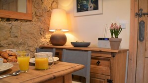 A breakfast setup with croissants, orange juice, and a lamp on a wooden table. - 2 Bed in Ilminster (oc-56523) (Dowlish Ford)