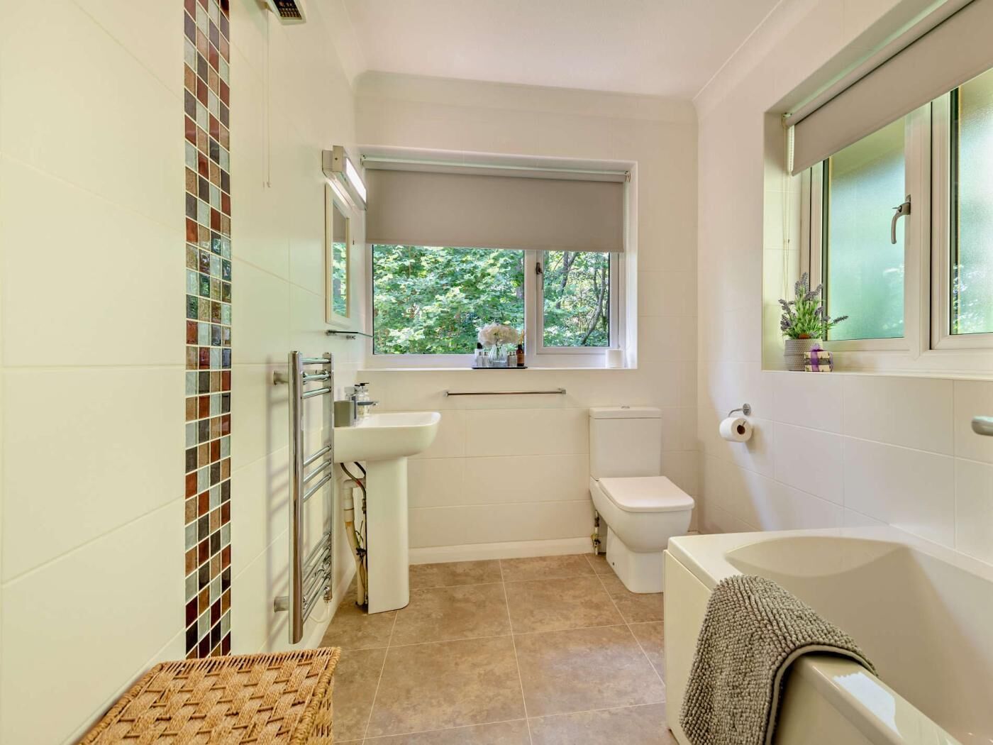 A bathroom with a toilet, sink, and bathtub.
