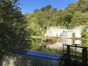 A waterfall, a calm lake, and a forested cliff. - 3 Bed in Buxton (oc-57037) (Cressbrook)