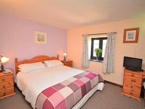 A bedroom with a bed, bedside tables, a television, and a window with curtains. - 2 Bed in Newton Abbot (oc-61775) (Ipplepen)