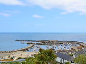 A coastal town with a marina, sandy beach, and buildings along the waterfront. - 2 Bed in Dorchester (oc-66192) (Bradford Peverell)