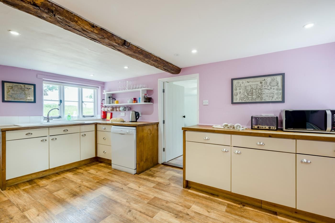 A kitchen with wooden cabinets, a dishwasher, and a microwave.