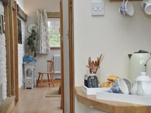 A kitchen area with a wooden countertop, a kettle, a teapot, and a jar of utensils. - 1 Bed in Cinderford (oc-73633) (Ruspidge and Soudley)