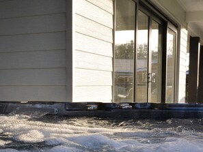 A house with a sliding glass door, a visible garage door, and a snow-covered ground. - 4 Bed in Oswestry (oc-75175) (Kinnerley)