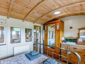 A wooden interior with a bed, a dresser, and a mirror. - 1 Bed in Exeter (oc-75423) (Longdown)