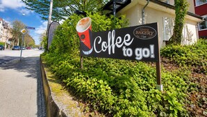A sign for a coffee shop with a cup of coffee and the text 'Coffee to go!' - BS1 Property 29 B/C Near Wiesbaden (Wiesbaden)