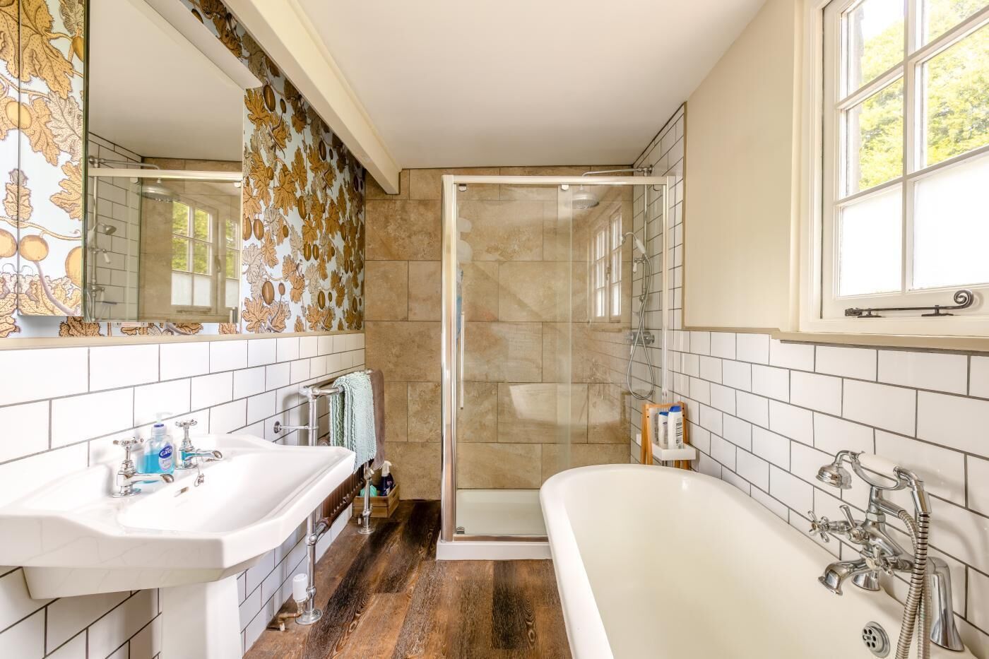 A bathroom with a shower, a sink, and a bathtub.