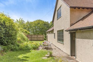 A house with a patio, a wooden fence, and a door. - 2 Bed in Minehead (oc-77363) (Withypool)