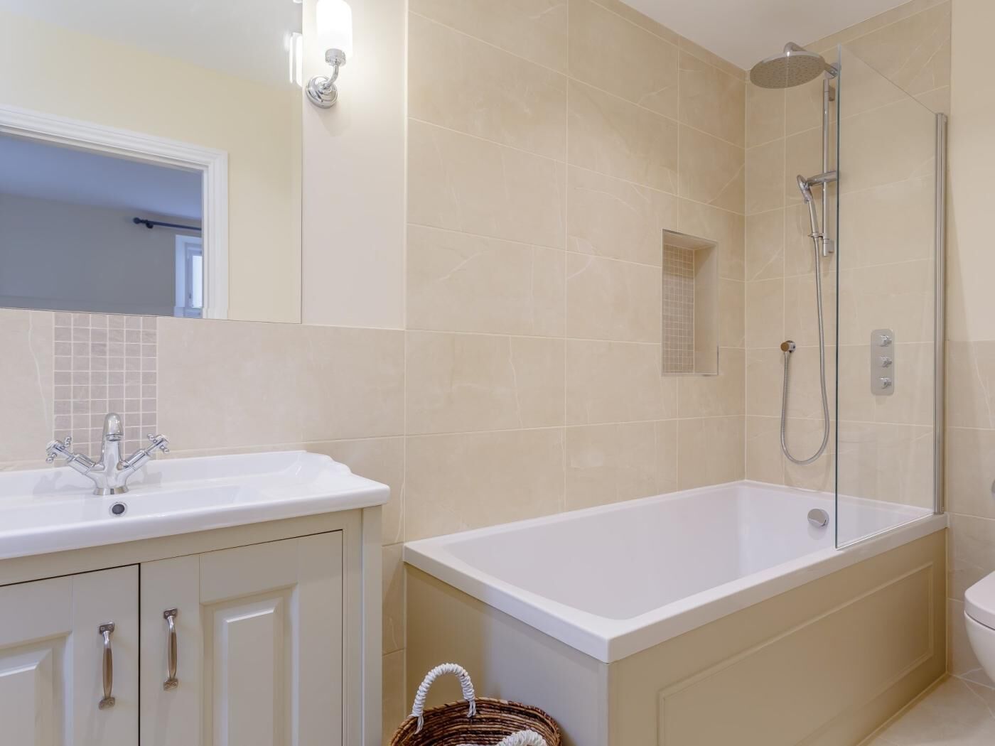 A bathroom with a white sink, a bathtub, and a shower area.