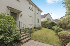 A residential building with a front garden, a staircase leading to the entrance, and a visible window. - 3 Bed in Bampton (oc-77931) (Bampton)