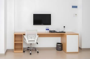 A modern office desk with a flat-screen TV, a white office chair, a small trash bin, and a nameplate on the wall. - Shankee Hotel Saigon Bui Vien Street (Ho Chi Minh City)