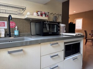 A modern kitchen with a microwave, toaster, and sink. - Simple and Private Living Home near Suvarnabhumi Airport 23 min (บางโฉลง)