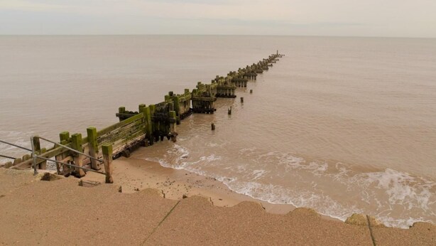 A long pier extending into a calm body of water, with a sandy beach on one side. - 3 Bed in Cromer (oc-81481) (Overstrand)