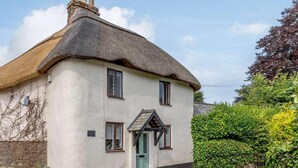A traditional thatched-roof house with a white exterior, a green door, and a small porch. - 1 Bed in Chulmleigh (oc-82389) (Chulmleigh)
