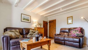 A living room with two leather sofas, a wooden coffee table, and a framed picture on the wall. - 2 Bed in Ashbourne (oc-82579) (Longford)