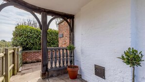 A white-walled building with a brick wall, a wooden gate, and a potted plant. - 2 Bed in Ashbourne (oc-82579) (Longford)