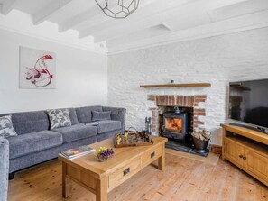 A living room with a sofa, a coffee table, a fireplace, and a television. - 4 Bed in Cardigan (oc-82766) (Rhos-hill)