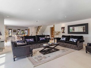 A spacious living room with a large sofa set, a coffee table, and a dining area in the background. - 2 Bed in Lowestoft (oc-82801) (Lound)