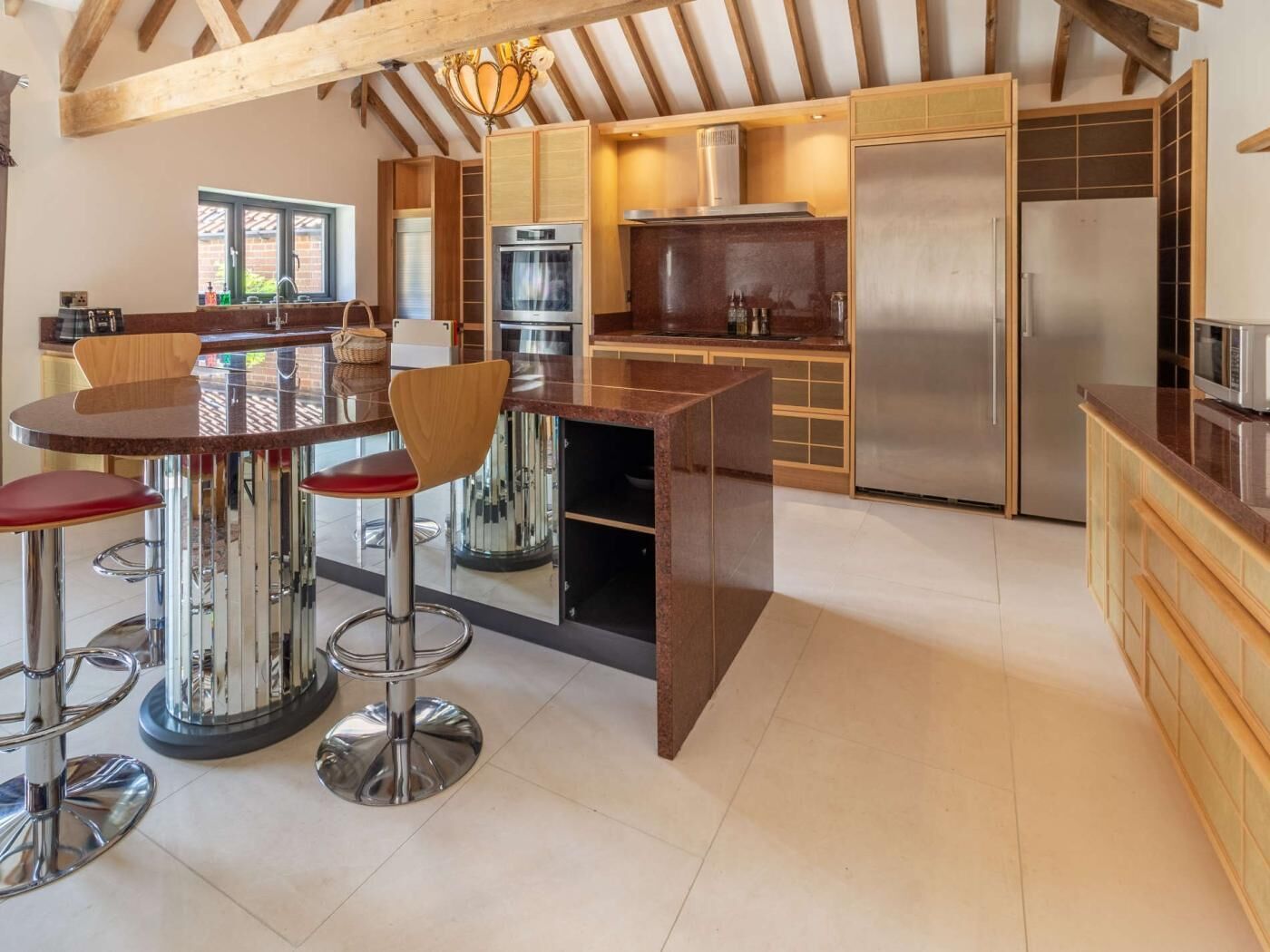 A modern kitchen with a central island, stainless steel appliances, and wooden accents.