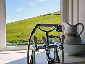 A bicycle in front of a window with a view of a green field. - 3 Bed in Biggar (oc-82924) (Biggar)