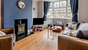 A living room with a fireplace, a television, a sofa, and a coffee table. - 3 Bed in Filey (oc-84007) (Filey)