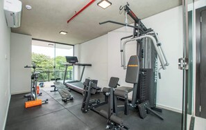A gym with cardio machines, weightlifting equipment, and a bench. - Corporate Stays Insignia City - A43 (Asunción)