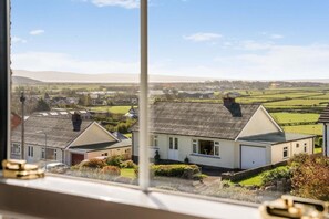 A residential area with houses, a clear sky, and distant hills. - 1 Bed in Grange-over-sands (oc-85499) (Cark)