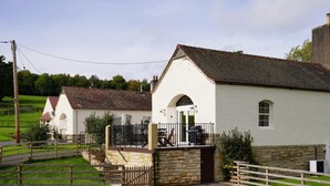 A rural property with a white building, a stone wall, and a wooden fence. - 2 Bed in Hawick (oc-86021) (Hawick)
