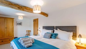 Ein Schlafzimmer mit einem Bett, einem Holzschrank und einem Sessel.