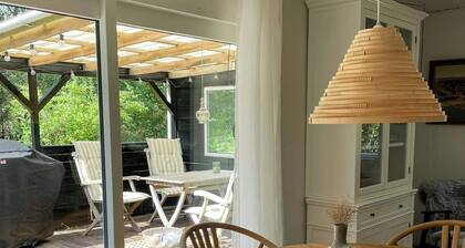 Log cabin on large nature plot with sun