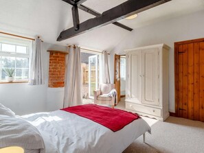 A bedroom with a bed, a wardrobe, a window, and a door. - 1 Bed in Norwich (oc-87414) (Hainford)